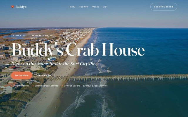 Buddy’s Crab House demo homepage, aerial photo of Surf City pier behind a white serif headline